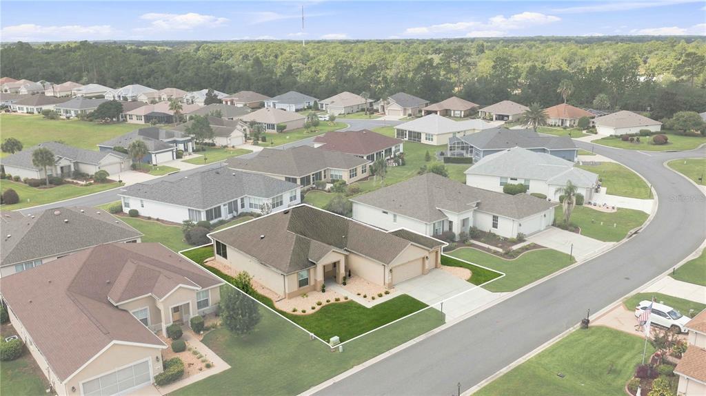An aerial view shows a single-story suburban house with a tan exterior and gray roof — 11811 SE 91ST CIRCLE, SUMMERFIELD, FL