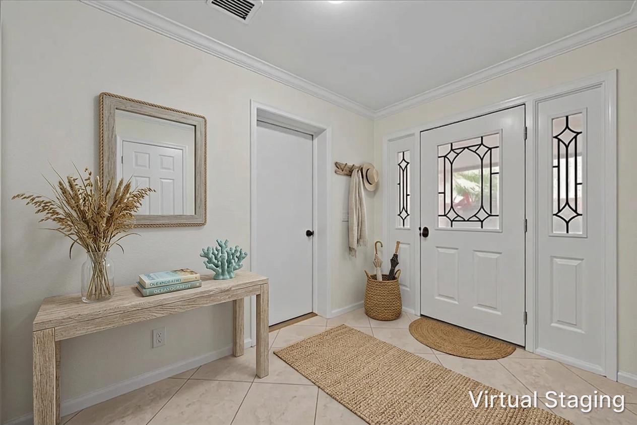 This virtually staged entryway features a console table, mirror, and a white front door — 17138 Waterbend Drive # 117, Jupiter FL 33477, JUPITER, FL