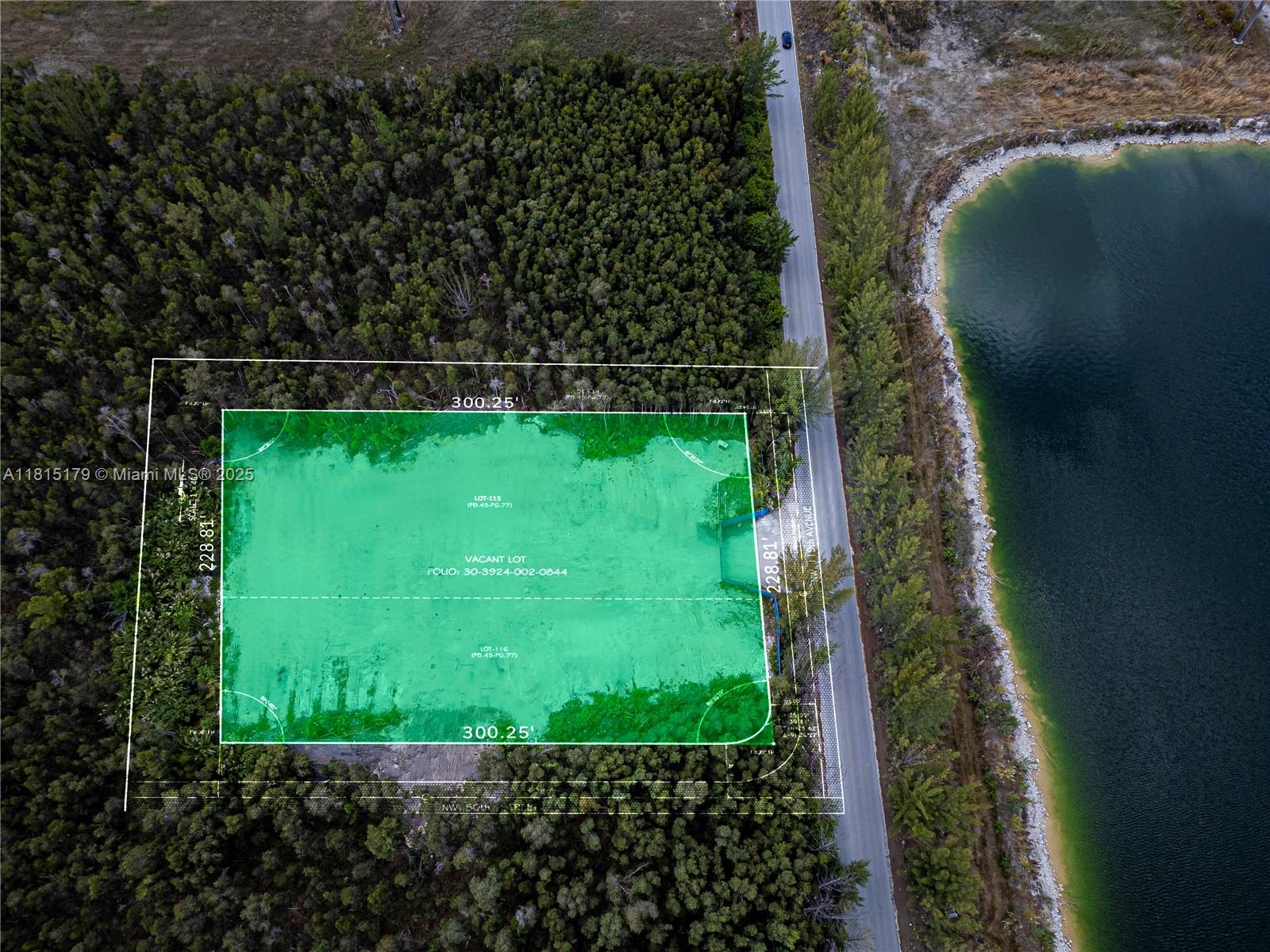 This aerial view shows a rectangular vacant lot highlighted in green next to a road — NW 122 Ave, NW 50 ST, Doral FL 33178, DORAL, FL