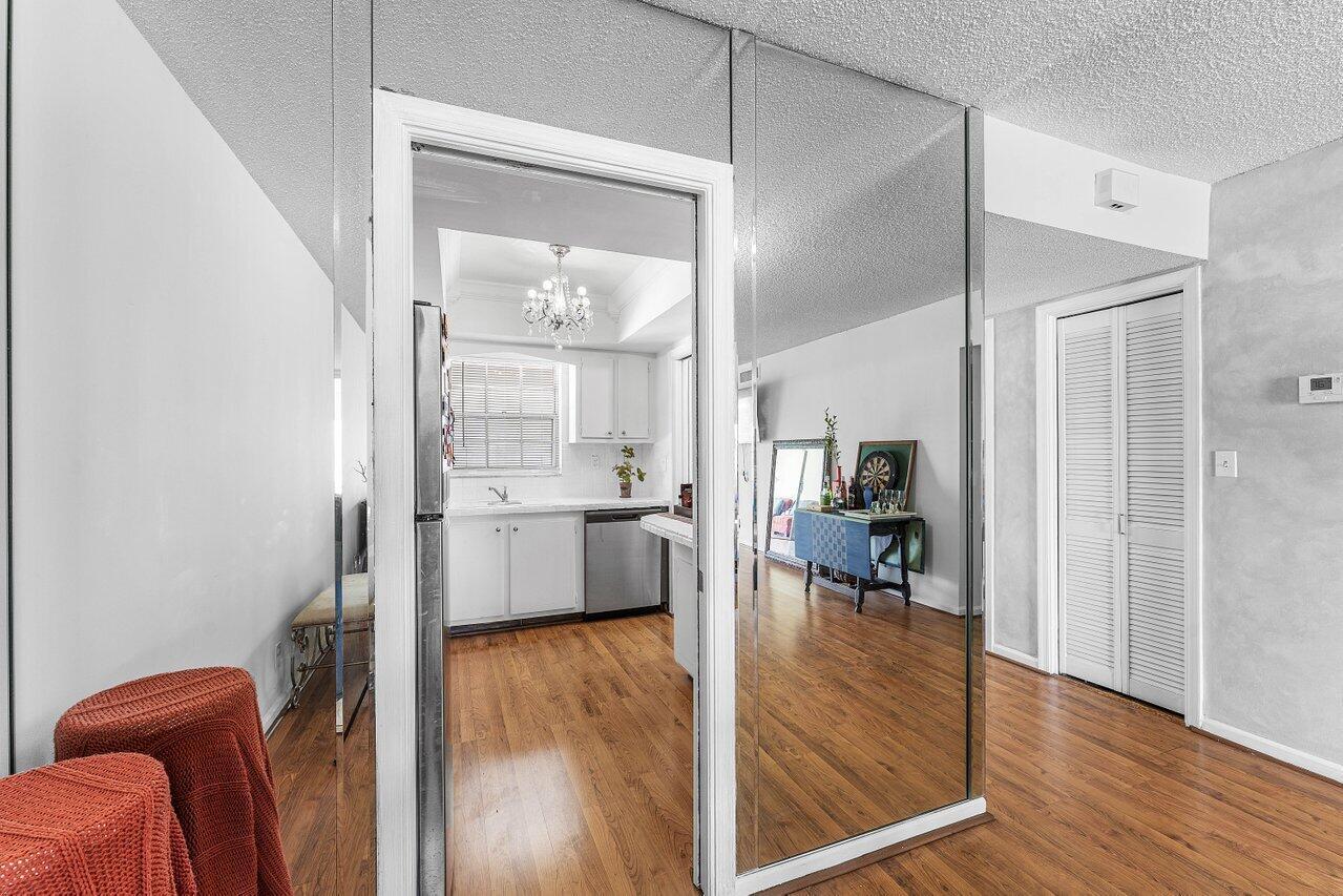 A view from a hallway looking into a kitchen through a doorway with mirrored walls — 157 Atlantis Boulevard # 301, Atlantis FL 33462, ATLANTIS, FL