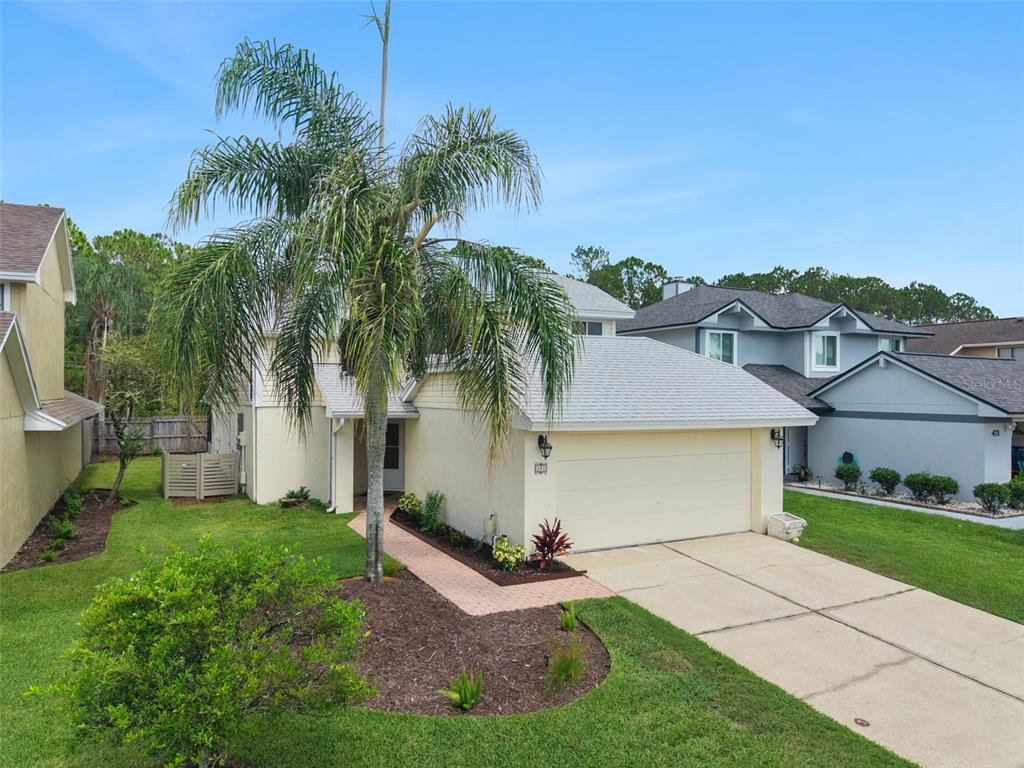 A two-story house with a palm tree in the front yard and a concrete driveway — 467 CIDERMILL PLACE, LAKE MARY, FL