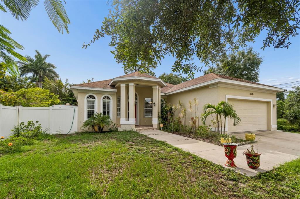 A single-story house with a beige stucco exterior, a two-car garage, and a front walkway — 8040 57TH STREET N, PINELLAS PARK, FL