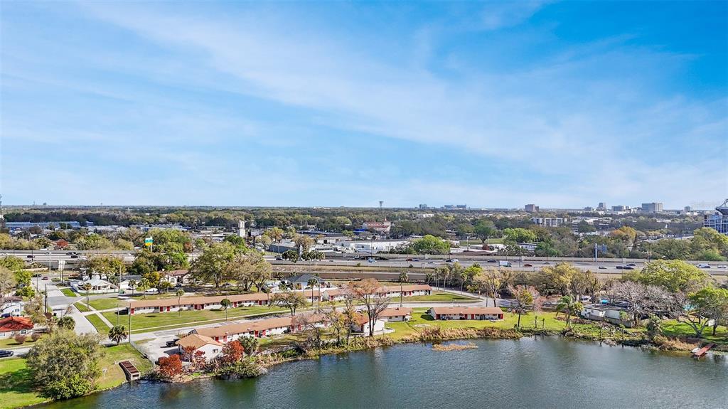 An aerial view shows a lakefront residential complex with a highway in the background — 2222 W SOUTH STREET, ORLANDO, FL