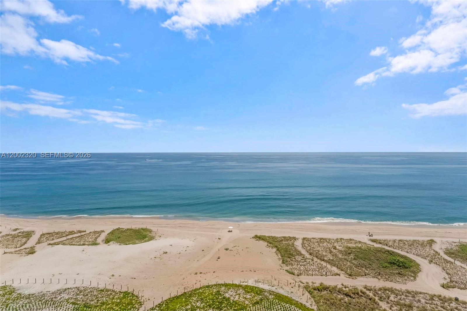 A high-angle view shows a sandy beach with dunes leading to the ocean — 900 N Ocean Blvd # 1202, Pompano Beach FL 33062, POMPANO BEACH, FL