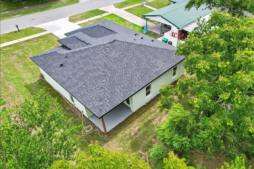 An aerial view of a single-story house with a gray shingled roof and a carport — 2225 W HOWARD PLACE, CITRUS SPRINGS, FL