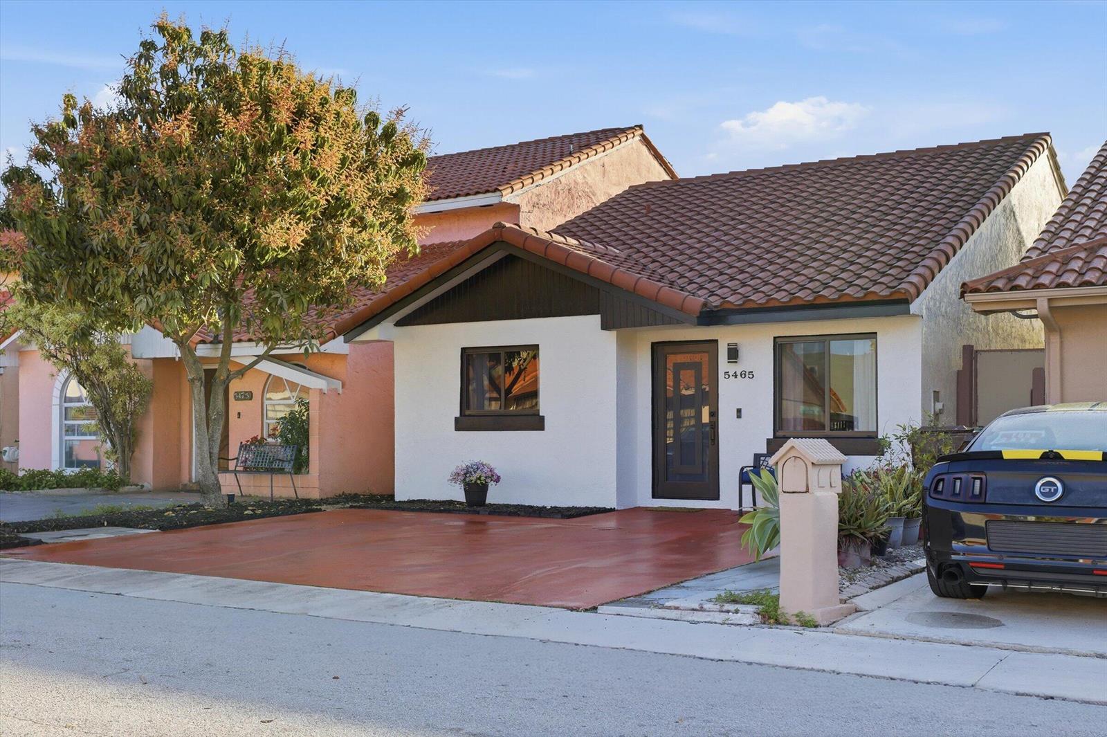 A single-story house with a white stucco exterior, brown tile roof, and a paved driveway — 5465 W 27th Lane, Hialeah FL 33016, HIALEAH, FL