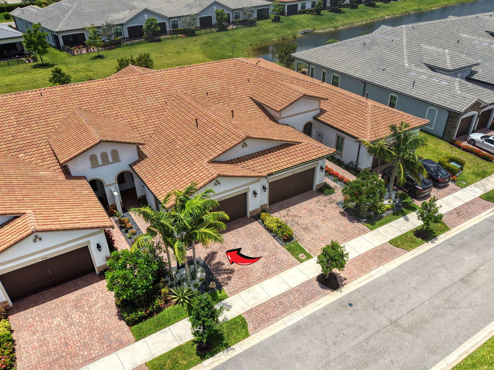 An aerial view shows the exterior of a residential building with a tiled roof — 7524 N Blue Spring Drive, Parkland FL 33067, PARKLAND, FL