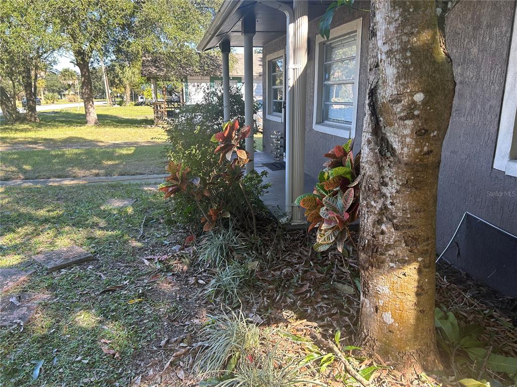 A view of a house exterior featuring a porch, columns, and landscaping — 1121 ORANGE AVENUE, SANFORD, FL