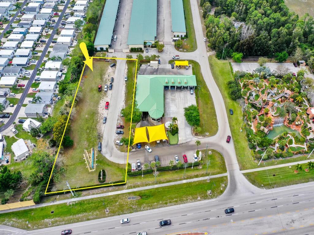 An aerial view shows a commercial property with a car wash and an adjacent vacant lot — S TAMIAMI TRAIL, BONITA SPRINGS, FL