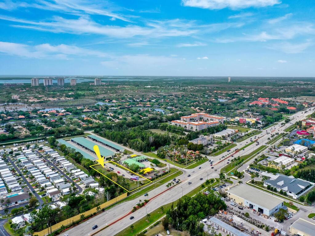 An aerial view shows a commercial property outlined in yellow next to a residential area — S TAMIAMI TRAIL, BONITA SPRINGS, FL