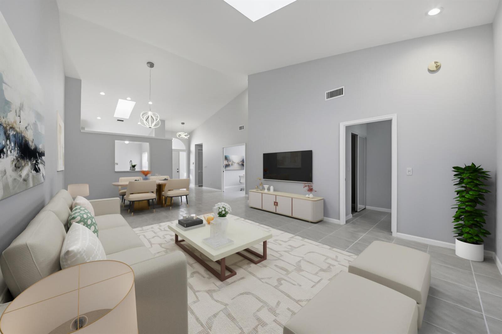 A living room with light gray walls, tile flooring, a white sofa, and a television — 7617 Island Breeze Terrace, Boynton Beach FL 33437, BOYNTON BEACH, FL