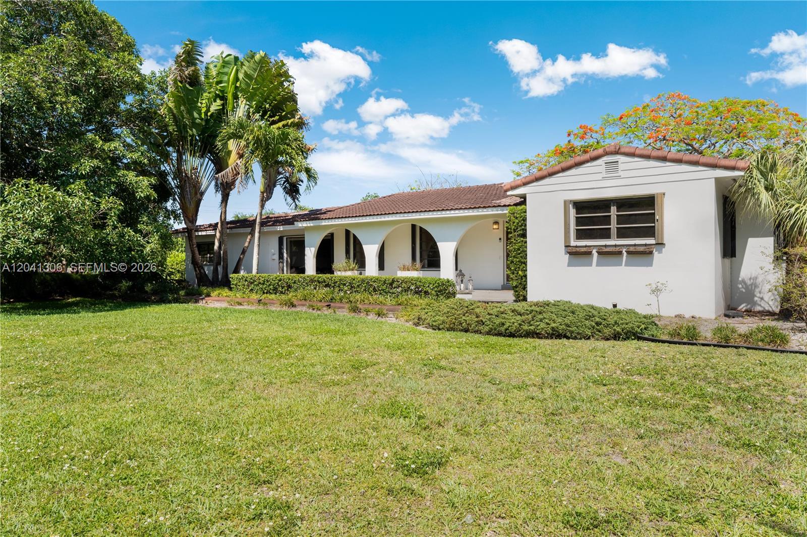 A single-story house with a tiled roof, arched porch, and a large front lawn — 8480 SW 66th St # 0, Miami FL 33143, MIAMI, FL