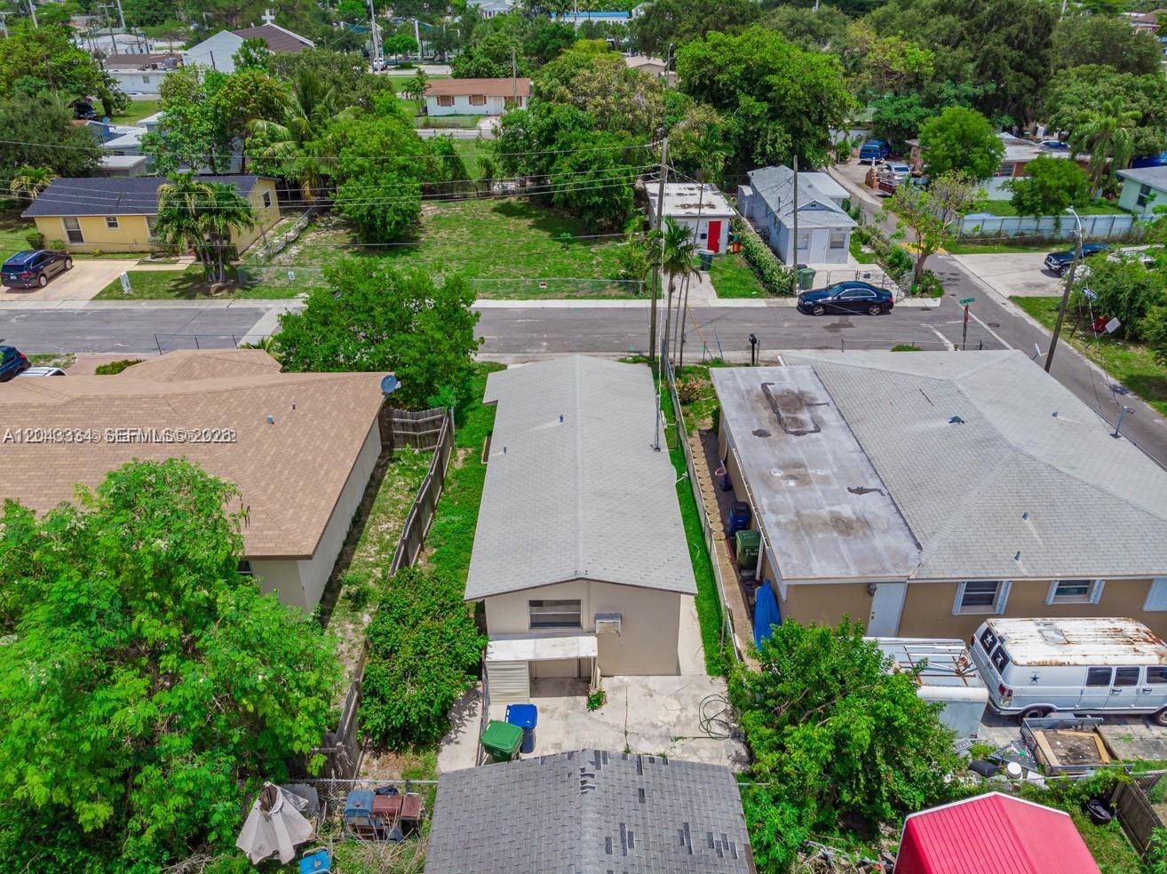 An aerial view shows a narrow residential building situated between two larger houses — 805 NW 3rd Ter, Hallandale Beach FL 33009, HALLANDALE BEACH, FL