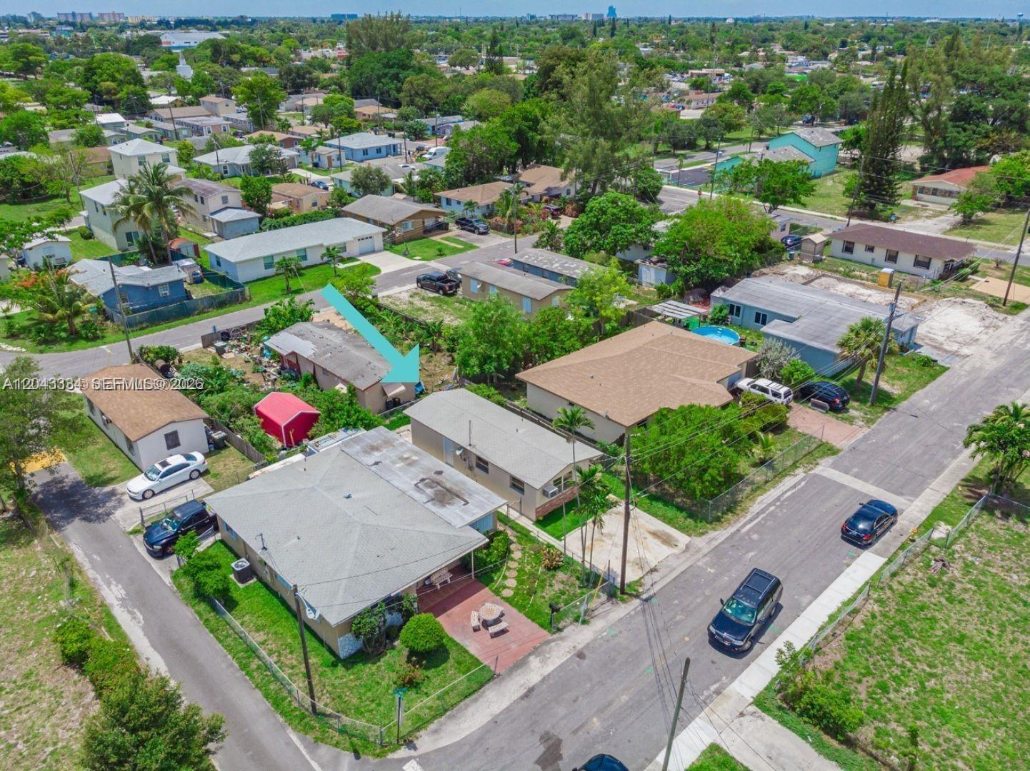 An aerial view shows a residential neighborhood with several single-story houses and parked cars — 805 NW 3rd Ter, Hallandale Beach FL 33009, HALLANDALE BEACH, FL