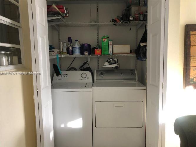 A laundry closet contains a white top-load washing machine and a matching dryer — 5813 SW 140th Ave # 5813, Miami FL 33183, MIAMI, FL