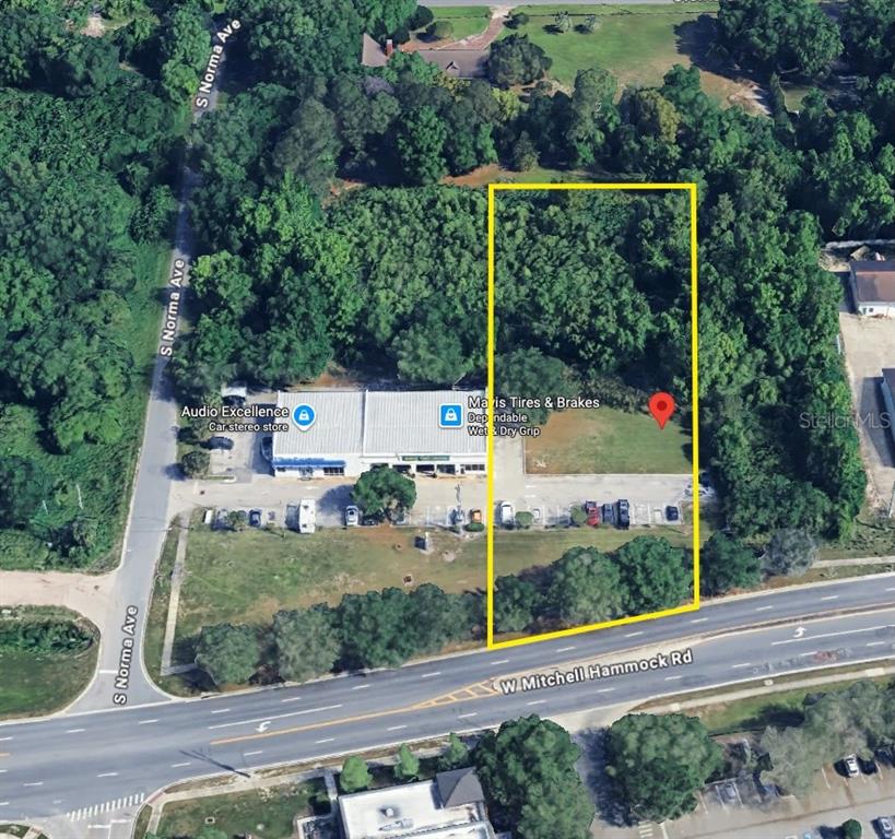 This aerial map shows a commercial property with a building and adjacent vacant land — 345 W MITCHELL HAMMOCK ROAD, OVIEDO, FL