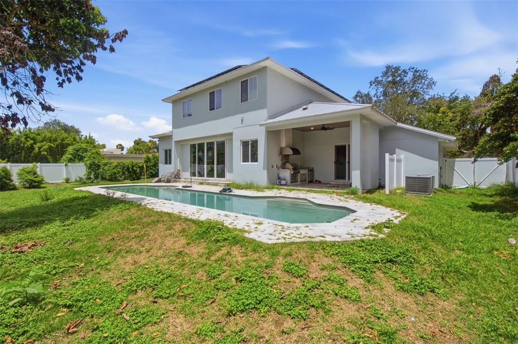 The exterior of a two-story house features a swimming pool and a covered patio area — 281 BREWER AVENUE, WINTER PARK, FL
