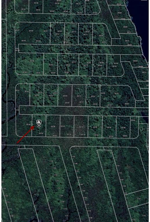 This is an aerial map showing a grid of undeveloped land parcels with a red arrow — 28150 HARBOUR SUNRISE DRIVE, PUNTA GORDA, FL