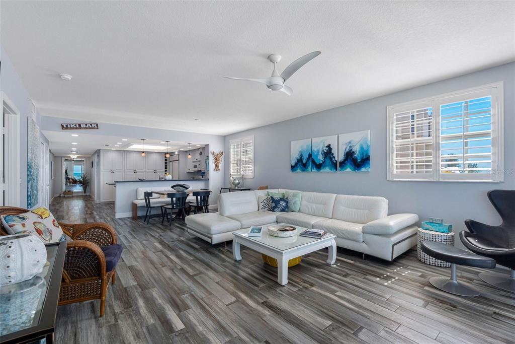 A balcony with brown chairs overlooks a sandy beach and the ocean under a blue sky — 19710 GULF BOULEVARD UNIT 301, INDIAN SHORES, FL