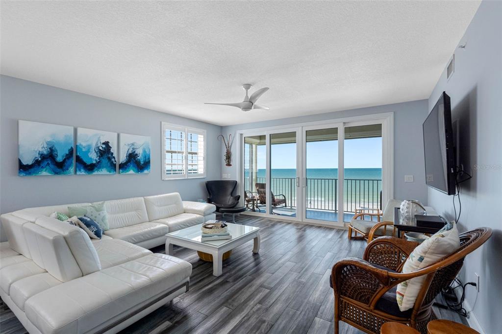 A balcony with a white metal railing overlooks a sandy beach and the ocean — 19710 GULF BOULEVARD UNIT 301, INDIAN SHORES, FL