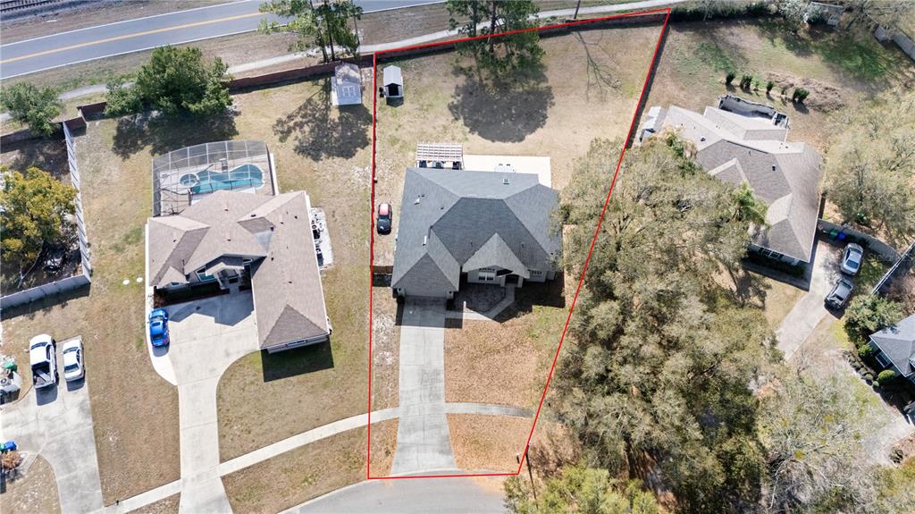An aerial view shows a single-family home on a trapezoidal lot with a concrete driveway — 134 ESTATES CIRCLE, LAKE MARY, FL