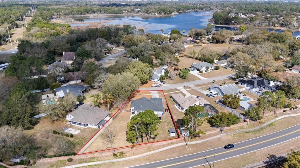 An aerial view shows a single-family house with a red-outlined property boundary near a road — 134 ESTATES CIRCLE, LAKE MARY, FL