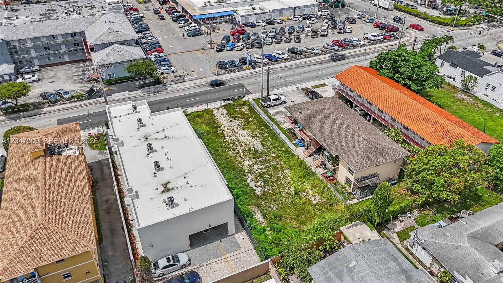 An aerial view shows a vacant rectangular lot bordered by residential buildings and a street — 1877 SW 7th St, Miami FL 33135, MIAMI, FL