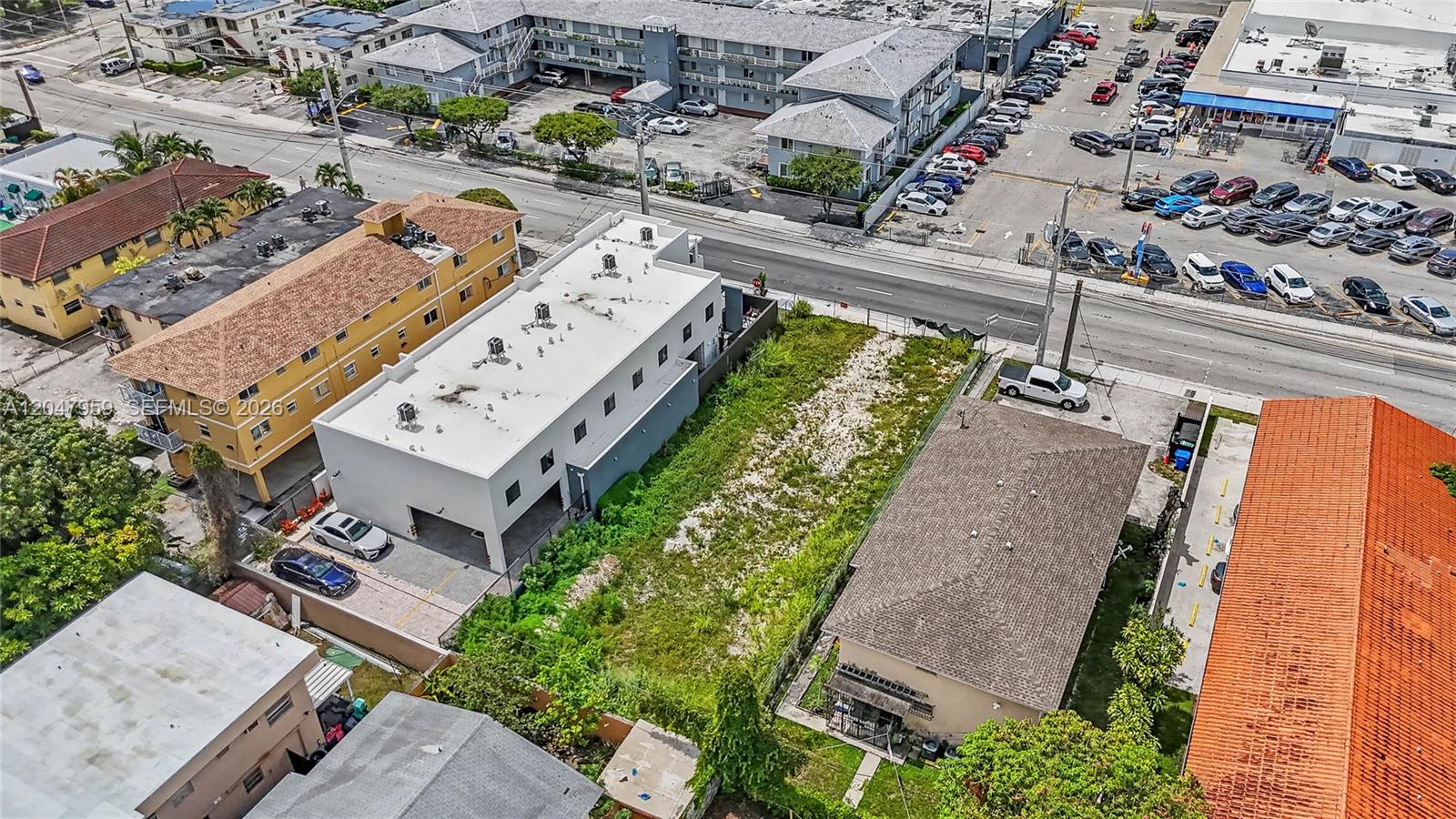 An aerial view shows a vacant rectangular lot situated between two residential buildings — 1877 SW 7th St, Miami FL 33135, MIAMI, FL