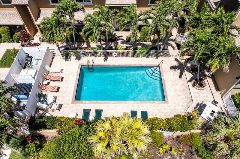 An aerial view of a rectangular swimming pool surrounded by a patio and palm trees — 3409 SE 8th Street # 6, Pompano Beach FL 33062, POMPANO BEACH, FL