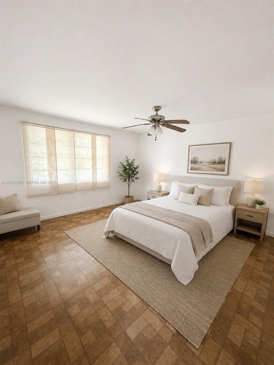 A bedroom features a bed with neutral bedding, a ceiling fan, and tiled flooring — 8480 SW 154th Cir Ct # 924, Miami FL 33193, MIAMI, FL