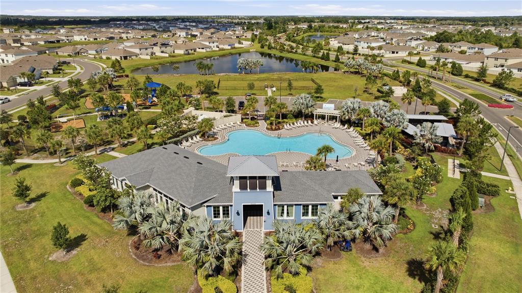 An aerial view of a community clubhouse with a swimming pool and surrounding residential neighborhood — 10622 EUSTIS DRIVE, PARRISH, FL