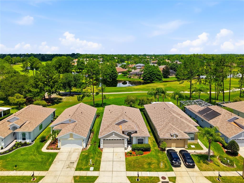 An empty room with light purple walls, beige carpet, and a large arched window — 23915 CORAL RIDGE LANE, LAND O LAKES, FL