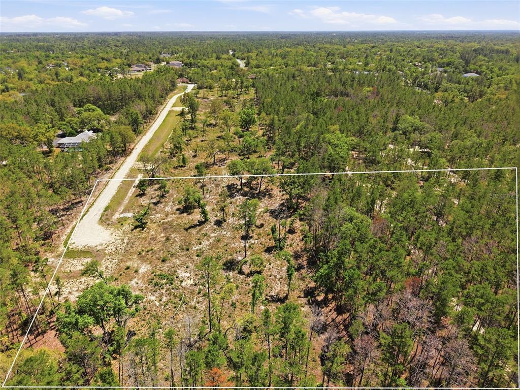 An aerial view shows a rectangular plot of land with scattered trees and sandy ground — 13331 HAVEN (LOT 4) TRAIL, WEEKI WACHEE, FL