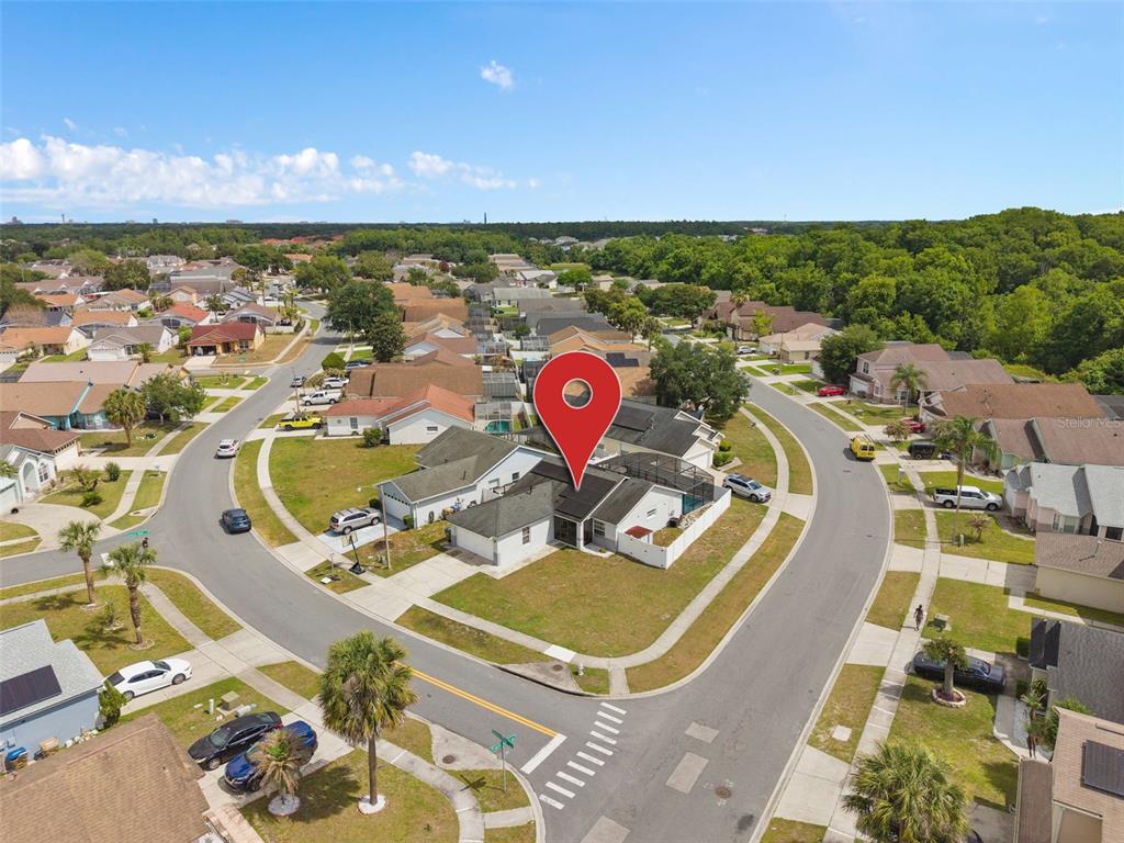 An aerial view shows a residential neighborhood with a red location pin over a house — 101 SENECA POINT TRL, KISSIMMEE, FL
