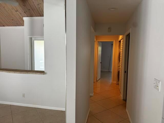 A view from a tiled room looking into a hallway with light-colored walls — 112 E Coral Fish Lane, Jupiter FL 33477, JUPITER, FL