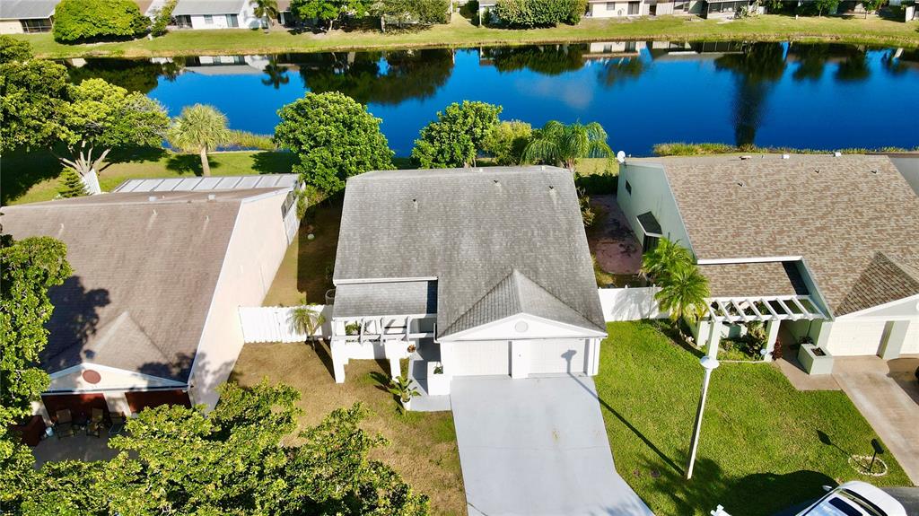 An aerial view shows a single-story house with a gray roof and a concrete driveway — 22 PAXFORD LANE, BOYNTON BEACH, FL