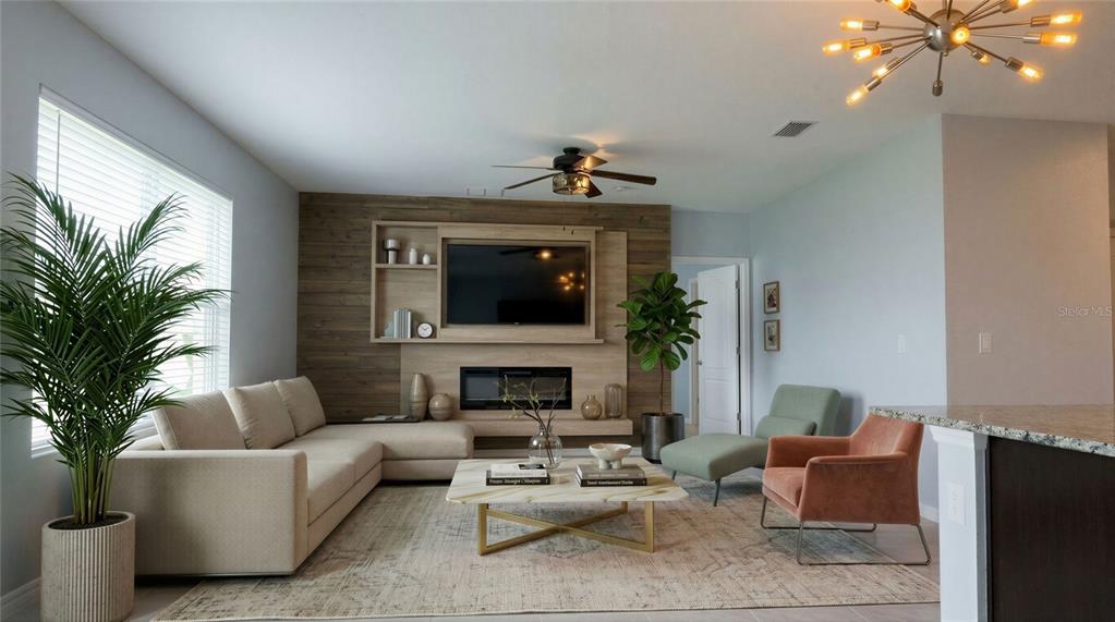 A living room features a wood-paneled accent wall with a built-in fireplace and television — 5110 FIDDLEWOOD WAY, ST CLOUD, FL