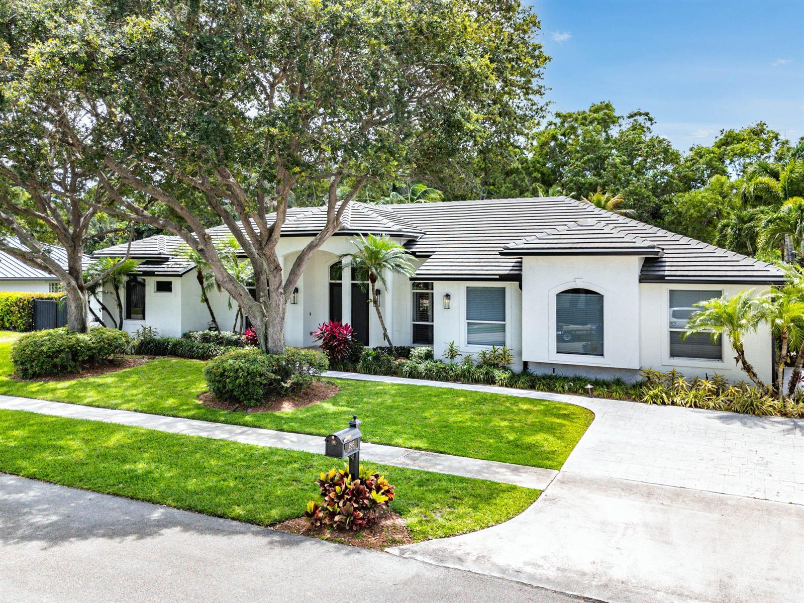 A single-story white house with a dark tile roof, large tree, and landscaped front yard — 1505 Addison Avenue, Boca Raton FL 33486, BOCA RATON, FL