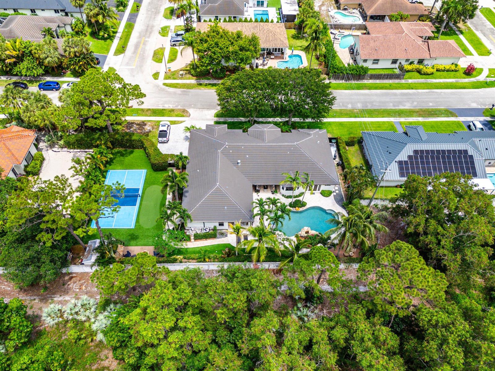 An aerial view shows a house with a pool, pickleball court, and putting green — 1505 Addison Avenue, Boca Raton FL 33486, BOCA RATON, FL