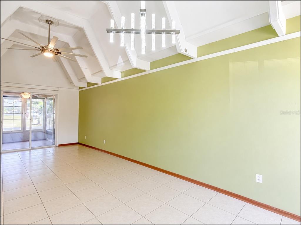The exterior of a single-story peach-colored duplex with two front doors and a covered porch — 523 CLUB CIRCLE, LAKE WALES, FL