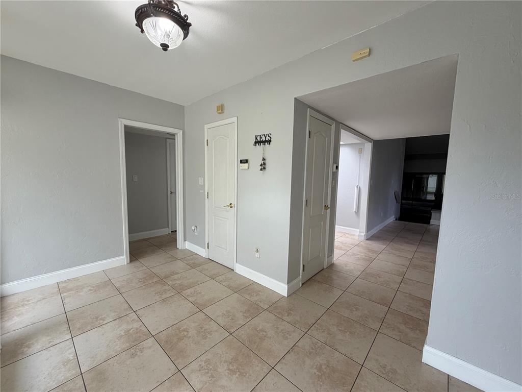 A tiled entryway features three white doors, a light fixture, and a key holder — 6 ROBYN LANE, HAINES CITY, FL