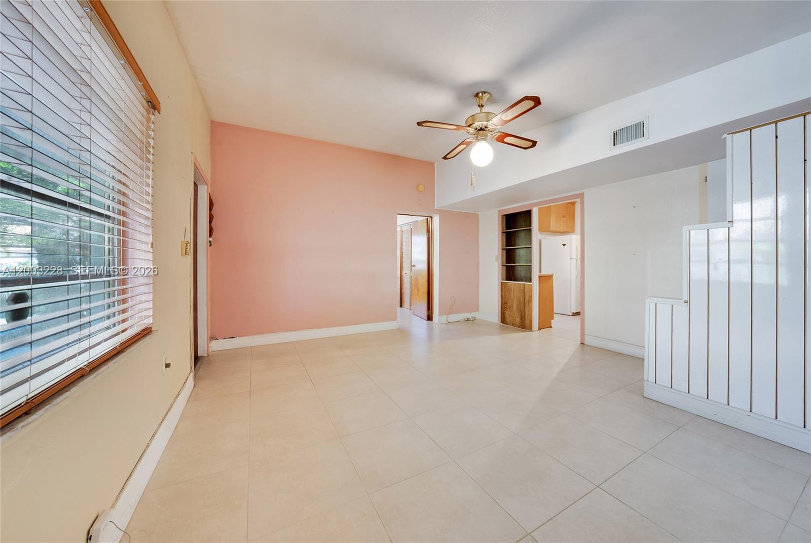 A living room features light tile flooring, a pink accent wall, and a ceiling fan — 14115 NW 6th Ave, North Miami FL 33168, NORTH MIAMI, FL