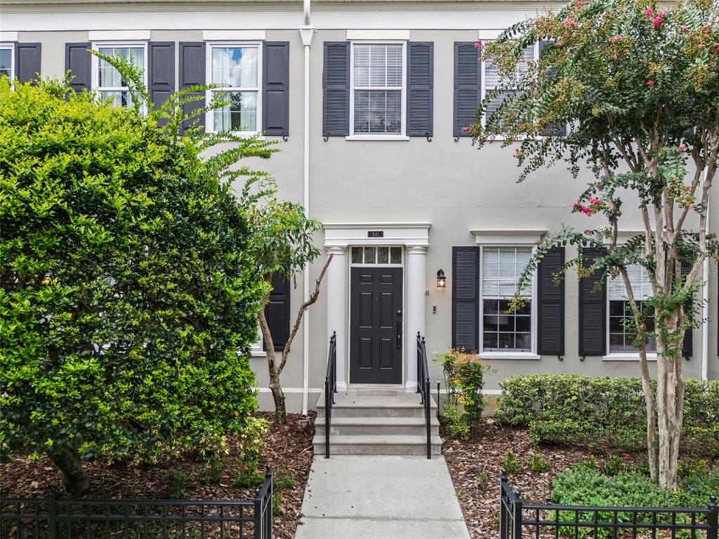 A gray two-story townhouse features a dark front door, black shutters, and front landscaping — 641 MULBERRY AVENUE, CELEBRATION, FL