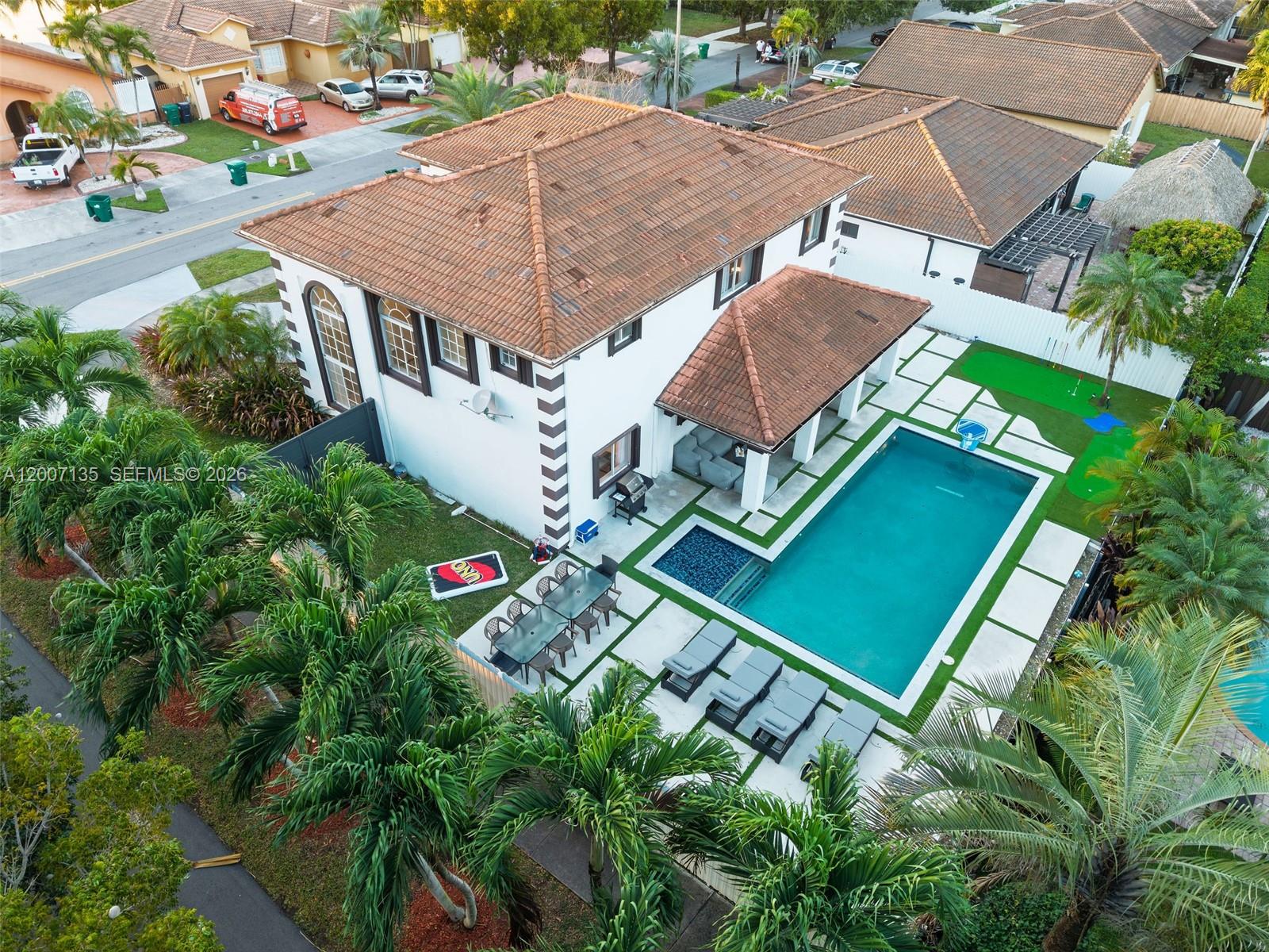 An aerial view shows a two-story house with a tiled roof, pool, and patio area — 5161 SW 159th Ct, Miami FL 33185, MIAMI, FL