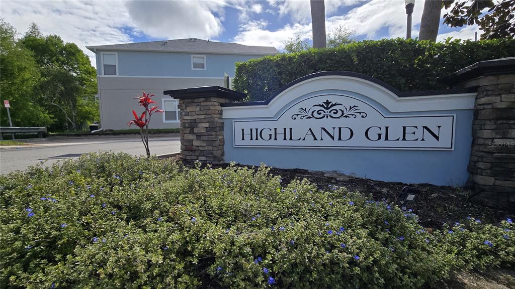 A stone and blue sign for Highland Glen stands in front of a residential building — 1507 TALISKER DRIVE, CLEARWATER, FL