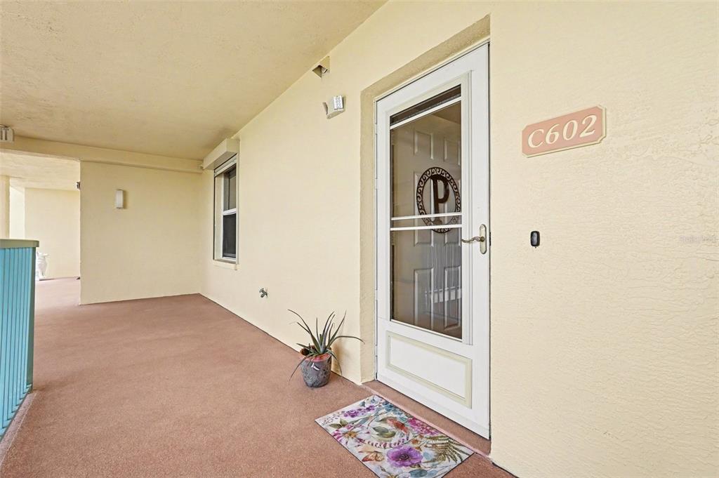A white storm door with a letter P decoration leads into unit C602 — 104 RIVERSIDE DRIVE UNIT 602, COCOA, FL