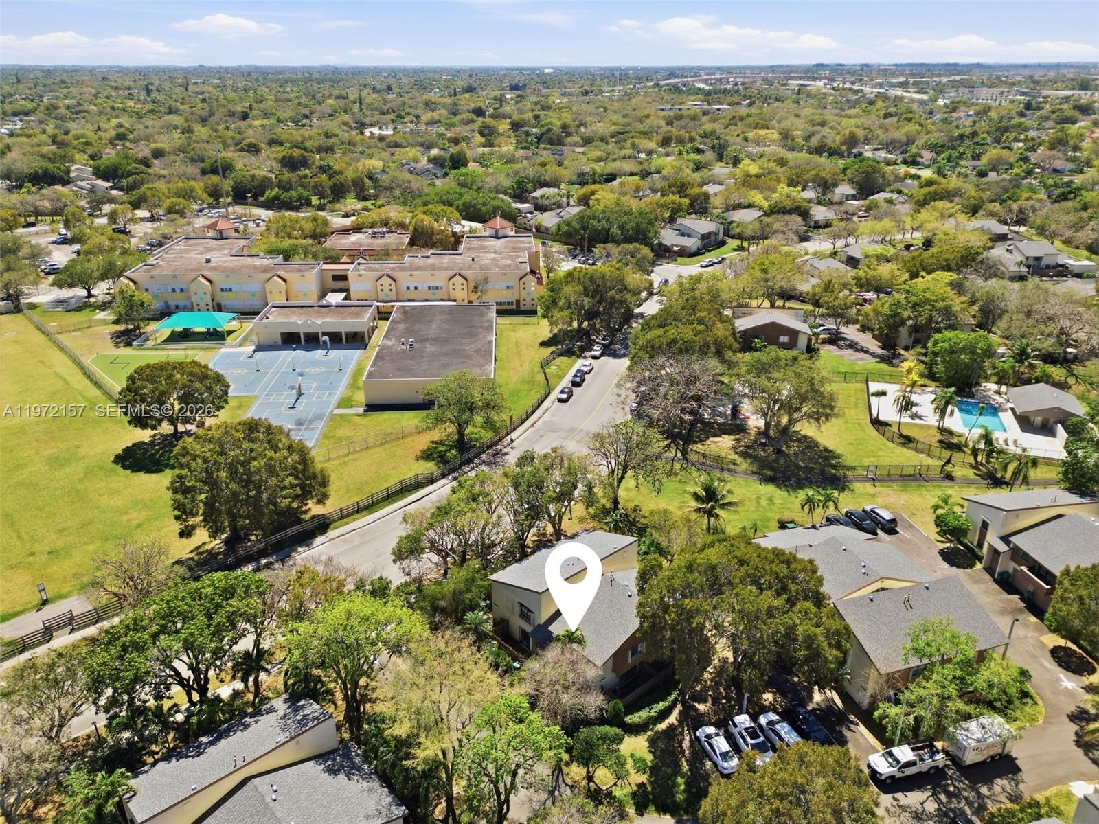 An aerial view shows a residential building with a location pin near a school — 11483 SW 109th Rd # 2F, Miami FL 33176, MIAMI, FL