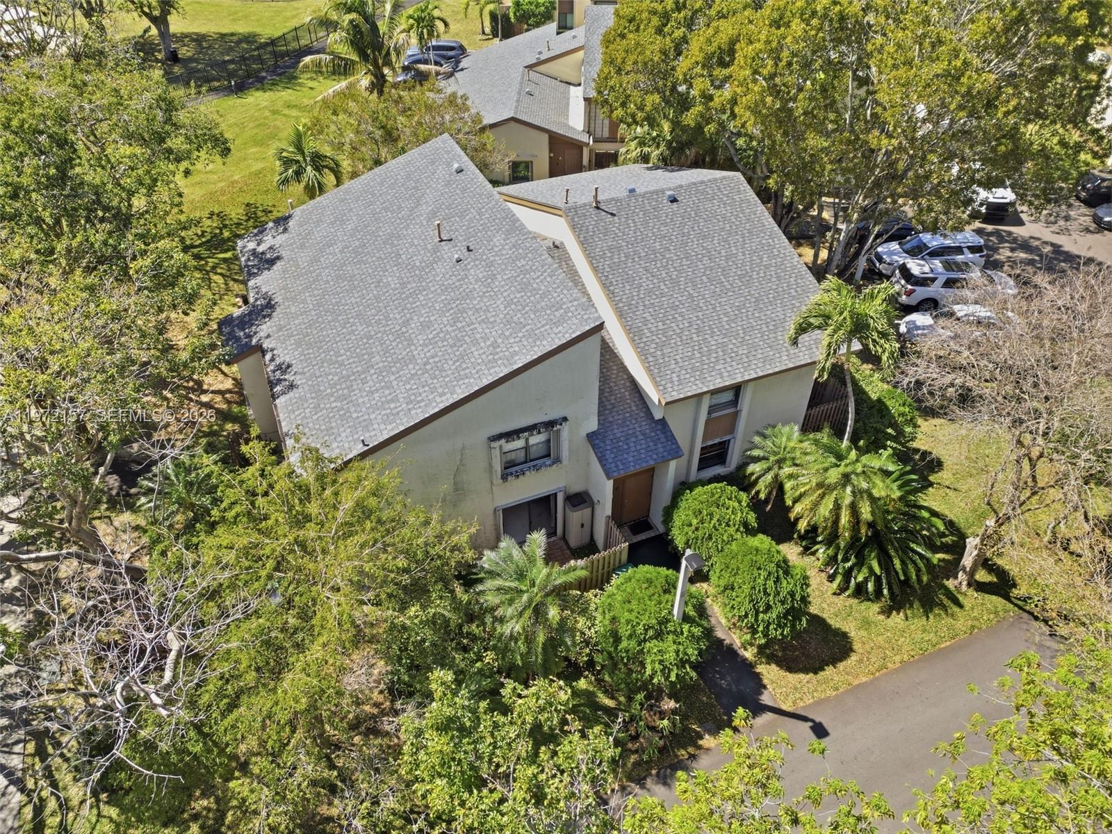 An aerial view shows a two-story house with a gray shingled roof and landscaping — 11483 SW 109th Rd # 2F, Miami FL 33176, MIAMI, FL