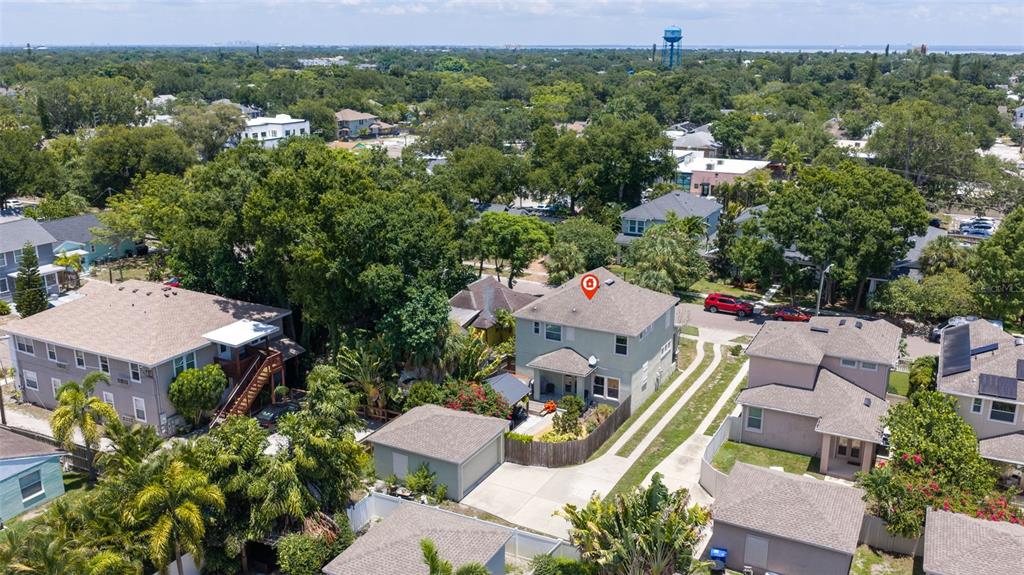 An aerial view shows a two-story house with a grey roof and surrounding residential properties — 1110 10TH STREET N, ST PETERSBURG, FL