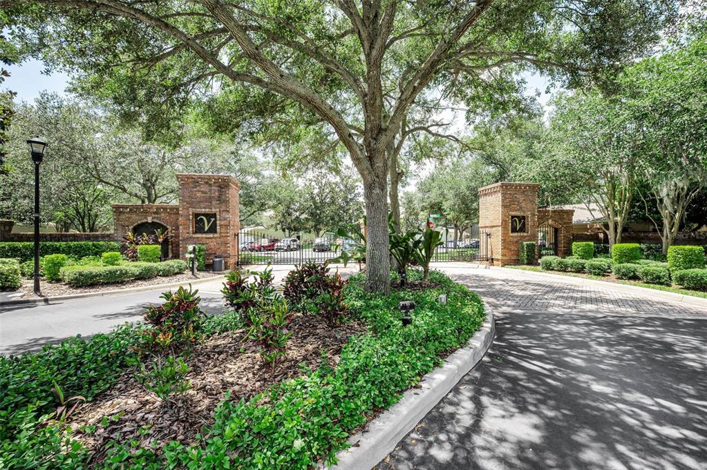 A gated entrance with brick pillars and mature trees leads into a residential community — 10155 HAVERHILL RIDGE DRIVE, RIVERVIEW, FL